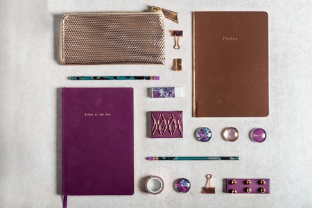 Notebooks for writing Dreams and Ideas, with different gold and maroon Stationery laying on grey background. Top View. Idea of Girly Office settings. Flat lay styleの写真素材