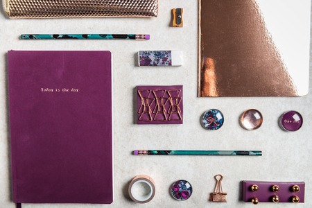 Notebooks for writing Dreams and Ideas, with different gold and maroon Stationery laying on grey background. Top View. Idea of Girly Office settings. Flat lay styleの写真素材