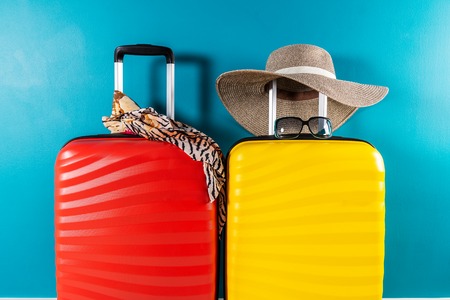 Bright and stylish cabin size suitcases and accessories as holiday conceptの写真素材