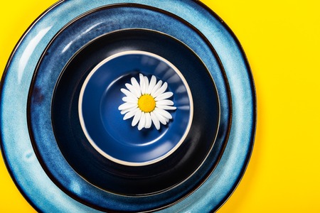 Empty Blue Plates on Bright Yellow Background, Top View, Copy Spaceの写真素材