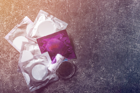 Condoms and vibration ring for pleasure, safe sex concept on dark backgroundの写真素材