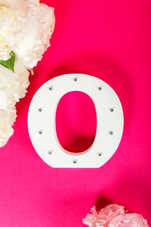 Wooden decorative letter O on pink backgroundの写真素材