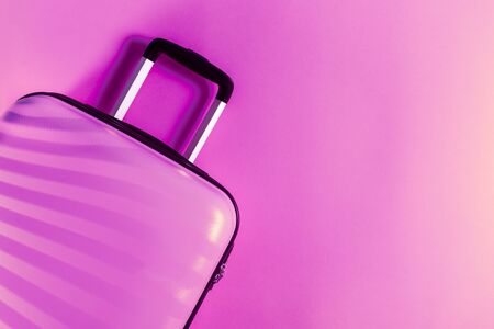 Bright and stylish cabin size suitcase on flat lay style. Easy travel with little baggage concept. Copy space.の写真素材