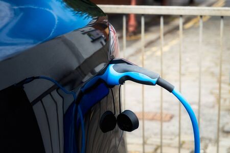 Charging modern electric car on the street car parkingの写真素材