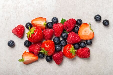 Fresh summer berries such as blueberries, strawberries, raspberries, top viewの写真素材