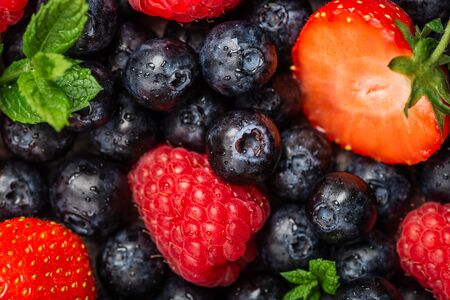 Fresh summer berries such as blueberries, strawberries, raspberries, top viewの写真素材