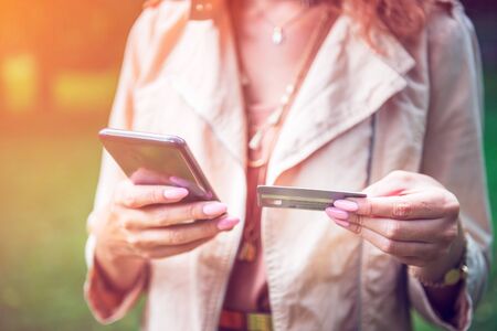 Woman is using mobile smartphone and credit cardの写真素材