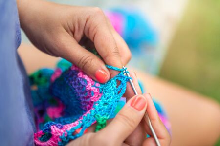 Craftswomans hands knitting shawl with crochetの写真素材