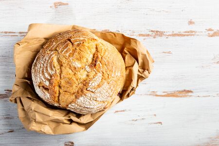 Warm freshly baked bread on wooden cutting boardの写真素材