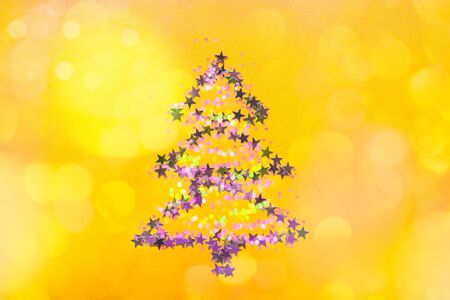 Christmas Tree made from stars on bright yellow backgroundの写真素材