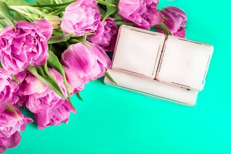 Wooden Blocks as Calendar for any Date and Spring Holidays, such as International Womens Day, Mothers Day, Easter, with beautiful purple tulips nearby on trendy green backgroundの写真素材