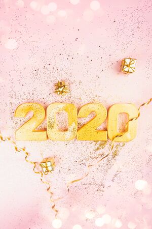 Happy New Year 2020. Golden digits 2020 are on pink background with glitter. Holiday Party...