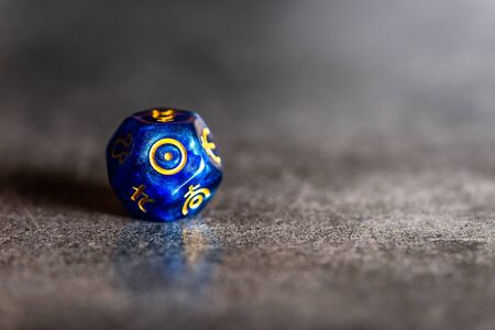 Blue Astrology Dice with symbol of the Sun on grey backgroundの写真素材