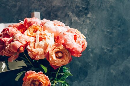 Fresh bunch of pink peonies and roses in the vase. Card Concept, pastel colors, grey backgroundの写真素材