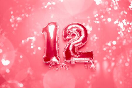 Silver Number Balloons 12 with bokeh lights. Holiday Party Decoration or postcard concept with top...