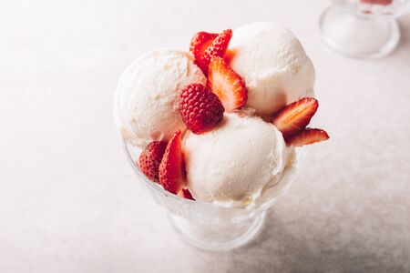 Vanilla Ice Cream Scoops with strawberry pieces, easy dessert at home