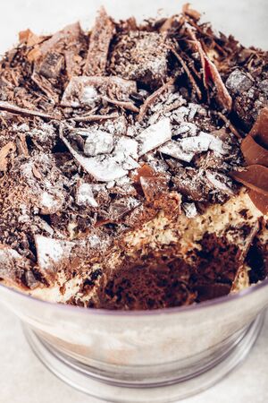 Family Pot of Irresistible Layered Billionaires Dessert made from mousse, Belgian chocolate sauce, digestive biscuit crumb and chocolate sponge. Finished with choco chunks and decorated with icingの写真素材