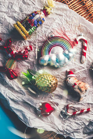 Box of Unusual Modern Christmas Baubles such as ice cream, rainbow, cat, balloon dog, pineapple, candy cane, nutcrackerの写真素材