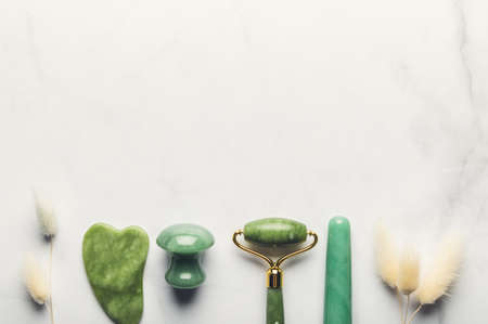 Set of Gua Sha massage tools for beauty facial massage therapy, Skin Care Anti-Aging Tools such as Green Aventurine Gua Sha Mushrooms, Wand, Jade face roller and stoneの写真素材