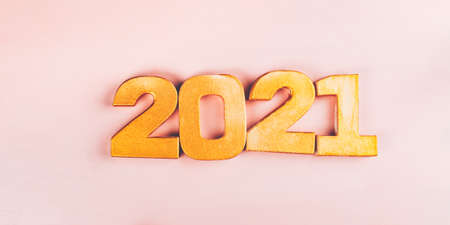 Happy New Year 2021. Golden digits 2021 are on pink background. Holiday Party Decoration or postcard...