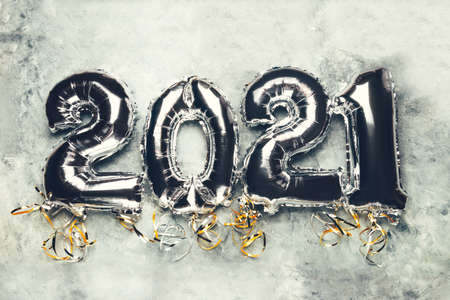 Balloon Bunting for celebration of New Year 2021 made from Silver Number Balloons. Holiday Party Decoration or postcard concept, on grey backgroundの写真素材