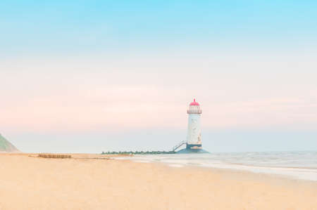 The Point of Ayr Lighthouse, also known as the Talacre Lighthouse, situated on the north coast of Wales, on the Point of Ayr, near the village of Talacre, unreal sunset with pastel colorsの写真素材