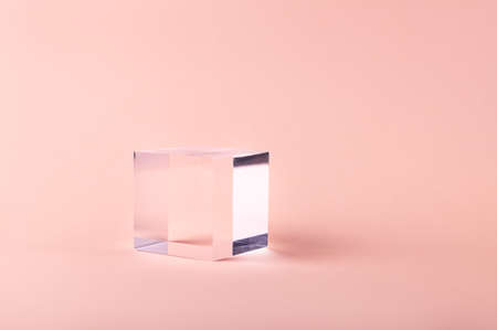 Acrylic Solid Display Block for Shop Windows on pink background, empty podium for product presentation, geometric stand for cosmeticsの写真素材