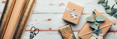 Gifts wrapped in recycled brown paper with handmade toppers , christmas background with minimalist style wrapping, top view flat layの写真素材