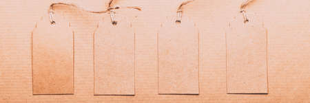 Brown Kraft Paper Gift Tags on recycled brown paper as background, zero waste and sustainable...