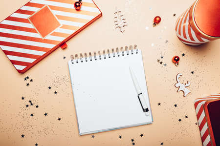 Empty open notebook for writing wish lists, goals, manifests. Reusable Red and white boxes for...