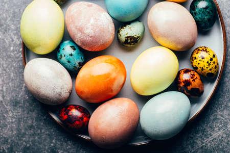 Easter eggs dyed in pastel colors with natural ingredients from red cabbage, onion, spinach, berries, turmeric, coffee. Homemade naturally dyed eggs.の写真素材