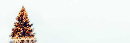 Abstract image of defocused or blurred christmas tree with bokeh as xmas lights, white background, space for text, christmas and new year card, banner sizeの写真素材