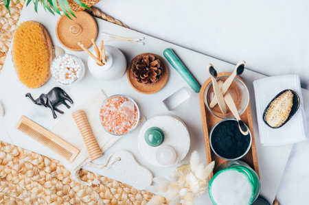 Set of Eco Friendly Bath Items, such as bath salts, reusable cotton pads, diffuser, bamboo toothbrush, jade rollers, natural wooden brush, fresh soap, charcoal powderの写真素材