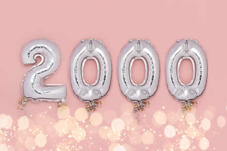 Balloon Bunting for celebration of 2000 made from Silver Number Balloons on pink background. Holiday...