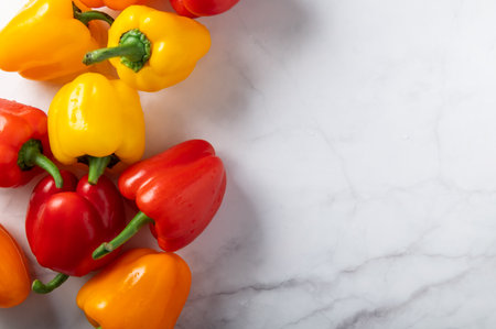 Fresh vegetables, colorful orange, red and yellow bell peppersの写真素材