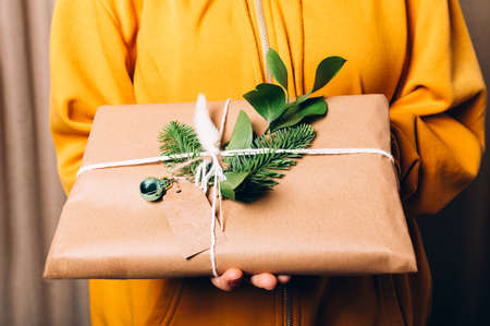 Hands are holding gift in eco paperの写真素材