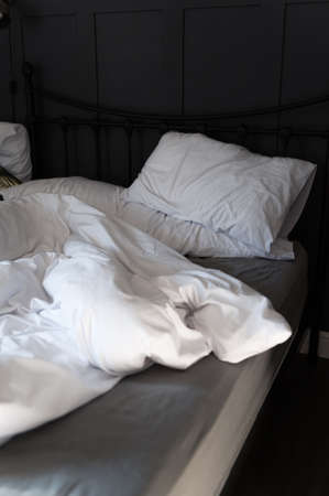 Soft pillows and duvet on comfortable bedの写真素材