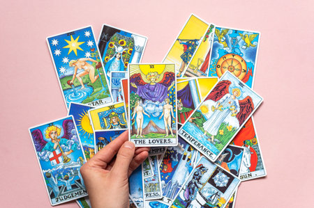 London, UK: 14 October, 2022: Pile of classic card of Rider Waite deck on pink backgroundのeditorial素材