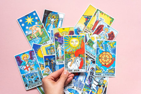 London, UK: 14 October, 2022: Pile of classic card of Rider Waite deck on pink backgroundのeditorial素材