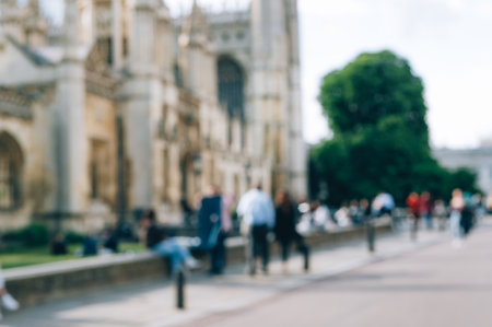 Cambridge, Cambridgeshire, United Kingdom - 01 June, 2022: Blurred photo of city centre near Kings College with cafes, shops, students and tourists on backgroundのeditorial素材