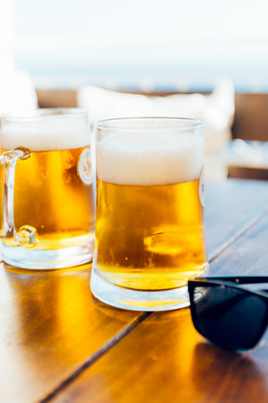 Glasses of cold craft light beer in open bar during summer vacation