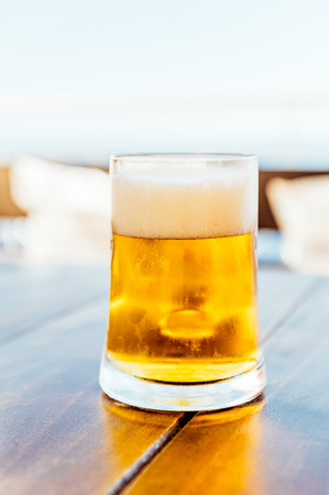 Glasses of cold craft light beer in open bar during summer vacation