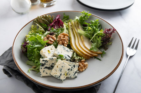Healthy Salad made from Green Salad Leaves, Rocket Salad, Slices of Fresh Pears, pieces of Blue Cheese, Walnuts and Sesame Seeds.の写真素材