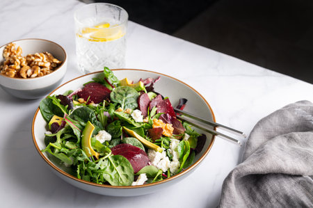 Healthy Salad made from Green Salad Leaves, Rocket Salad, Slices of Beetroot, Avocado, pieces of Feta Cheese, Walnuts and Sesame Seeds.の写真素材