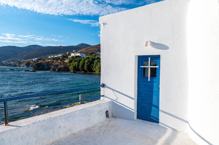 Empty quiet Stavros Beach with the picturesque church of the Holy Cross at Tinos island, Greece. Perfect place to embrace the Aegean Seaの写真素材