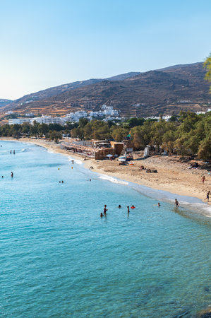 Kionia, Tinos, Greece: July 24, 2022: People on Kionia Beach swimming, the place to embrace the Aegean Sea, Tinos, Greeceのeditorial素材