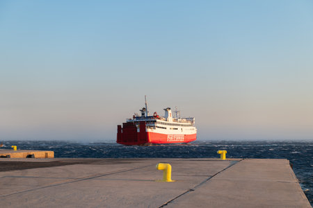 Tinos, Greece: July 17, 2022: Express Ferry aproaching port of Tinos island in city centre, Cyclades, Greeceのeditorial素材