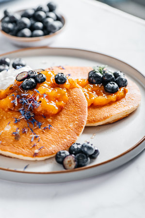 Fresh American Pancakes with orange jam, blueberries and coconut yogurt, perfect breakfastの写真素材