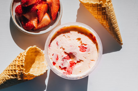 Easy Homemade no-churn strawberry ice cream in pot. Delicious and easy to make at home ice cream made from condensed milk, cream and strawberriesの写真素材