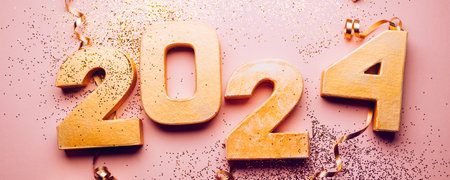 Happy New Year 2024. Golden digits 2024 with glitter and xmas decorations nearby. Holiday Party Decoration or postcard concept with top view and copy space.の写真素材